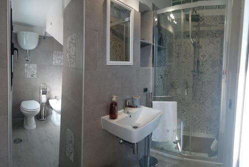a bathroom with a sink and a shower and a toilet at Home 56 vacation home in Salerno