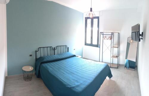a bedroom with a bed with a blue blanket at Home 56 vacation home in Salerno