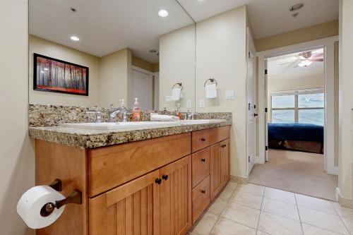 a bathroom with a sink and a large mirror at Base Camp One 403 in Granby