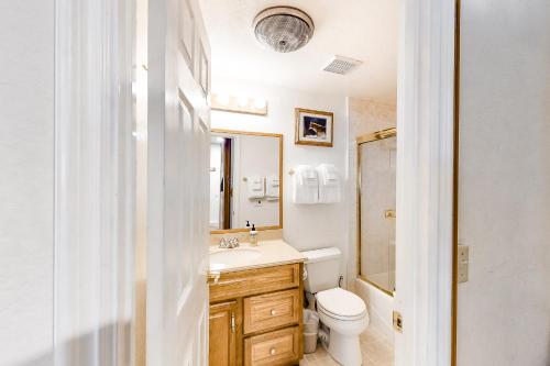 a bathroom with a sink and a toilet and a mirror at Hidden Valley 26 D in Mammoth Lakes