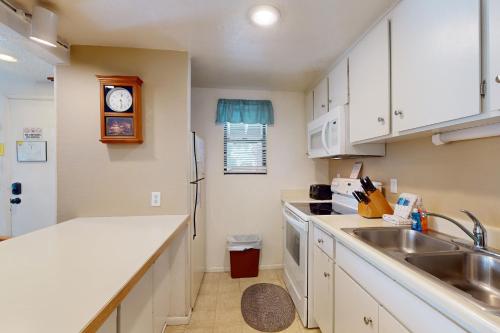 a kitchen with white cabinets and a sink at Hidden Valley 30 D in Mammoth Lakes