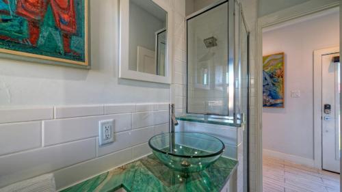 a bathroom with a glass bowl on a counter at Modern Coastal Home w Balcony Views Firepit Prime Port A Location Casa Blanca by AvantStay in Port Aransas