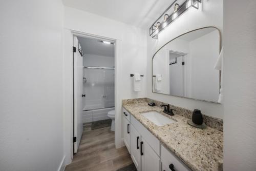 a white bathroom with a sink and a mirror at The Drift in Brian Head
