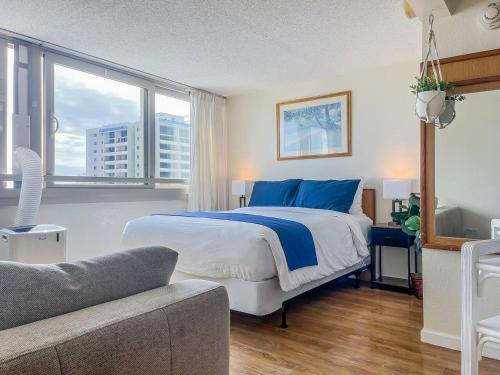 a bedroom with a bed and a large window at Two Amazing Views in One Spacious Condo Getaway in Honolulu