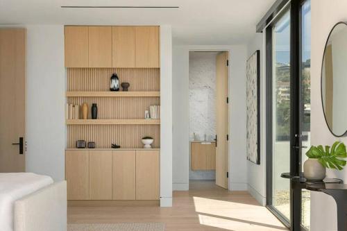 a living room with wooden cabinets and a hallway at Luxurious Malibu 6BR Estate with Pool, Theatre, Views in Malibu Beach