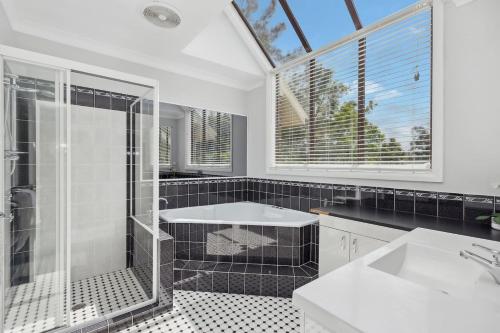 a bathroom with a shower and a sink at Dora Creek Escape with Pool and Spa in Dora Creek