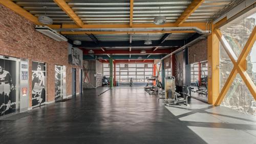 an empty gym with a large brick wall at The Midnight Bloom Suite in Mexico City