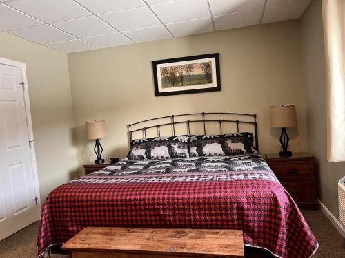 a bedroom with a bed with a plaid blanket at Loon Mountain Escape Comfortable Room Near Everything in Lincoln