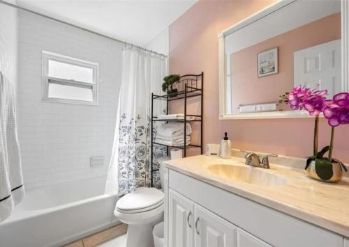 a bathroom with a sink and a toilet and a mirror at Villa W pool in Clearwater in Clearwater