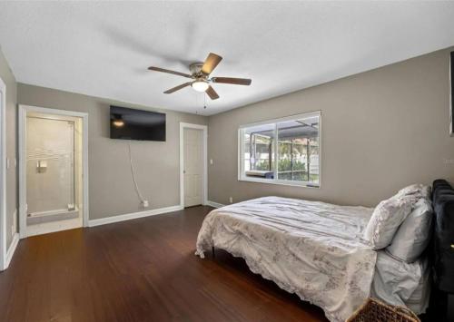 a bedroom with a bed and a ceiling fan at Villa W pool in Clearwater in Clearwater