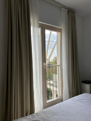 a bedroom with a bed and a large window at Patrinia in Vrijesno