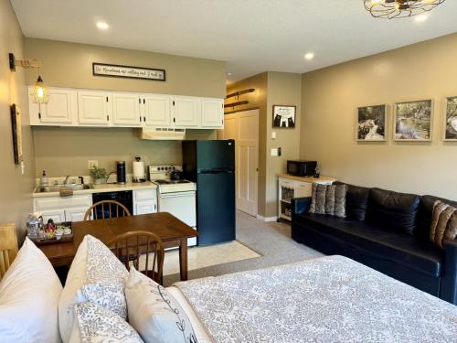 a living room and kitchen with a couch and a table at Studio Apt with stunning Mountain Views in Lincoln