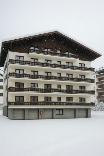 a building with snow on the ground in front of it at TinyAlps in Saalbach Hinterglemm