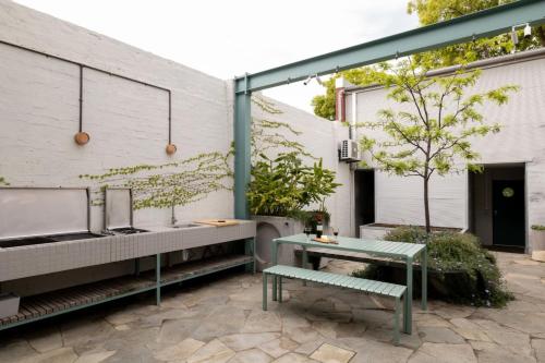 a patio with a bench and a table at Chic Seddon Retreat Near the CBD in Seddon