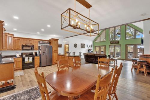 a kitchen and dining room with a table and chairs at Whiskey Cove Lakefront 2 Fireplaces 2 FirePits in Baneberry