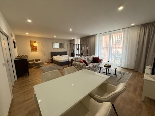 a living room with a white table and chairs at Veleslaveenka in Plzeň