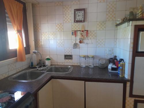 a kitchen with a sink and a counter top at La Casa de Oli in Chascomús