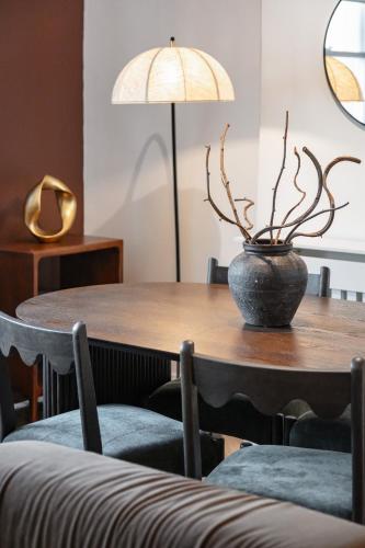 a table with a potted plant on top of it at The Portobello Collection in London