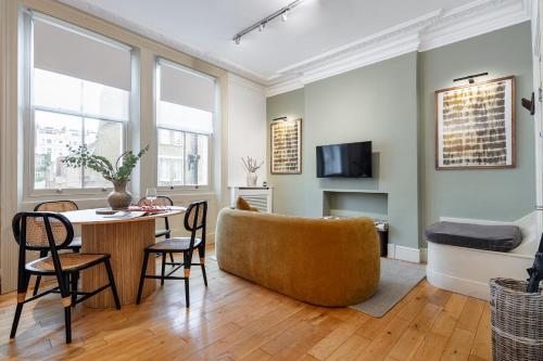 a living room with a table and a couch at The Portobello Collection in London