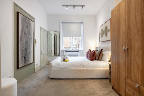 a bedroom with a bed and a window at The Portobello Collection in London
