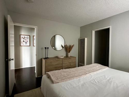 a bedroom with a bed with a mirror and a dresser at The Nest Manhattan Beach, Partial Ocean View in Los Angeles