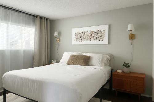 a bedroom with a white bed and a window at The Nest Manhattan Beach, Partial Ocean View in Los Angeles