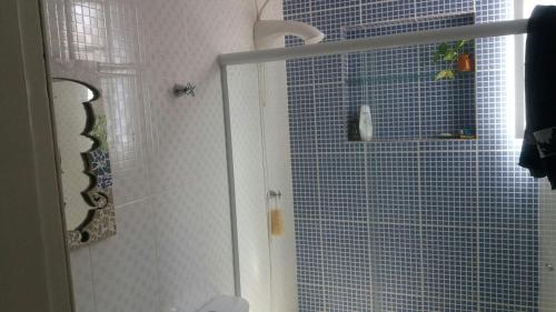 a shower with a glass door in a bathroom at summer house 2026 in Tramandaí