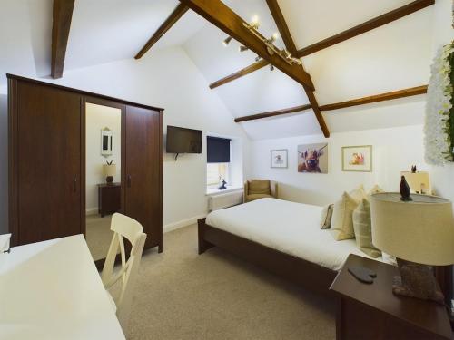 a bedroom with a bed and a table and a desk at Queen Victoria apartment Sleeps 6 in Stanhope