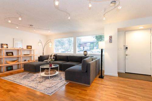 a living room with a couch and a table at Spacious Retreat 3 Miles to Airport 12 to Seattle in Burien