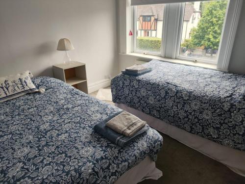 a bedroom with two beds and a window at Victorian House with 4 Bedrooms 9 Beds 13 Guests 2 Bathrooms Parking in Caversham