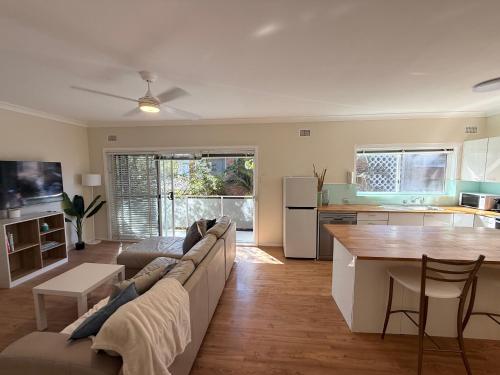 a living room with a couch and a table at 2 Bedroom Apartment - Heart of Cronulla in Cronulla