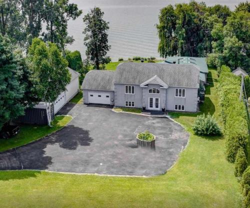 an aerial view of a house with a large yard at Heated Indoor Pool - Maison au Bord du Lac in Rigaud