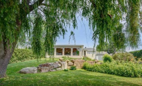 a home with a large yard with a tree at Heated Indoor Pool - Maison au Bord du Lac in Rigaud