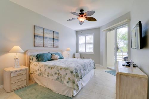 a bedroom with a bed and a ceiling fan at Waterfront Punta Gorda Condo with Pool Access! in Burnt Store Marina