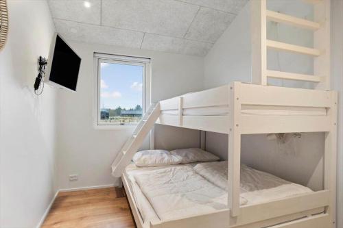 a white bunk bed in a room with a window at TV1697-Jerup-Engsig-Baekvej-42 in Bratten Strand