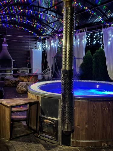a jacuzzi tub in a room with lights at Банний Двір in Kryvyi Rih