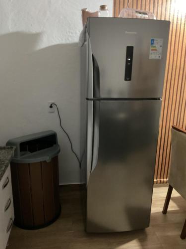 a stainless steel refrigerator in the corner of a kitchen at Casa de campo in Extrema