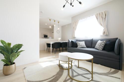 a living room with a blue couch and a table at Skytree Neighbors close to Asakusa & Tokyo Skytree in Tokyo