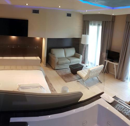 a living room with a bed and a couch at Hotel Griso Collection in Malgrate