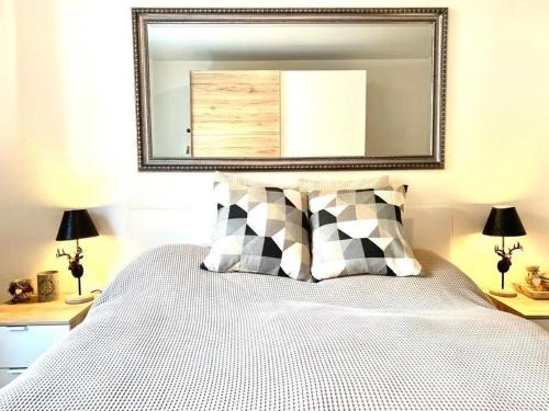 a bedroom with a bed with a mirror above it at Ferienwohnung Gian in Davos