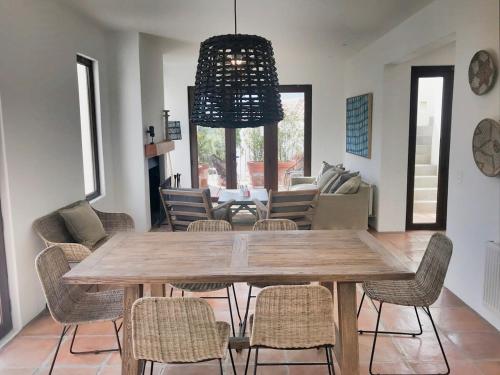 a dining room with a wooden table and chairs at Casapueblo Rent Cachagua CP 02 in Cachagua