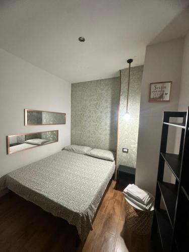 a bedroom with a bed in a room at Spàzio apartments Alcalà in Catania