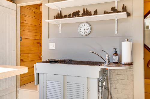 a kitchen with a sink and a clock on the wall at Direct Lake Access! Quiet Waukewan Retreat in Winona
