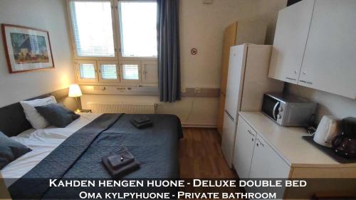 a small bedroom with a bed and a microwave at Hotel 24 - Karihaara - Kemi in Kemi