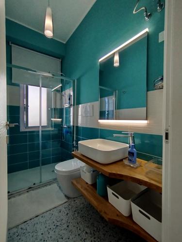 a bathroom with a sink and a toilet and a mirror at Seaview Allegra in Montesilvano