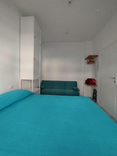 a bedroom with a large bed with blue sheets at Seaview Allegra in Montesilvano