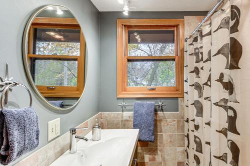 a bathroom with a sink and a mirror at Mille Lacs Lake Retreat! Cabin with Private Dock in Bayview