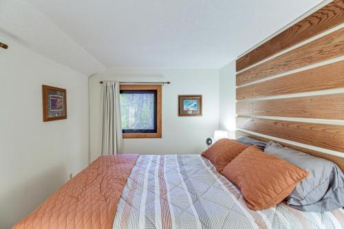 a bedroom with a bed with a large wooden headboard at Mille Lacs Lake Retreat! Cabin with Private Dock in Bayview