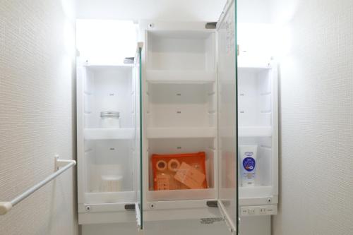 a glass refrigerator with its door open in a room at Skytree Neighbors close to Asakusa & Tokyo Skytree in Tokyo
