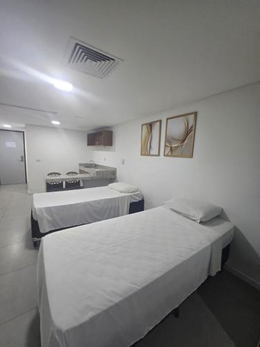 a hospital room with two beds and a stove at Hotel Imperial Flat in João Pessoa